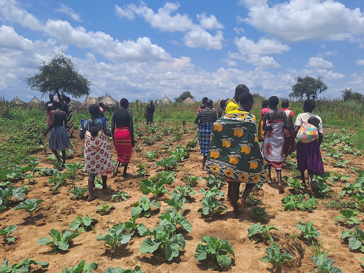 Women walking together through their gardens in Karamoja